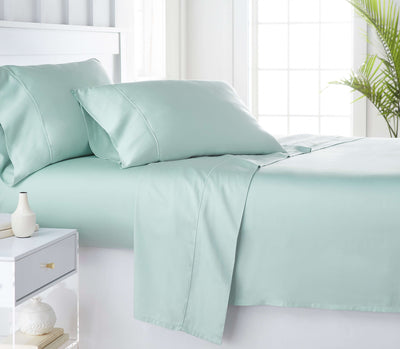 Green organic bamboo bed sheets on the bed