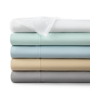 Stack of 100% organic bamboo sheets in the color white, green, blue, sand, and grey